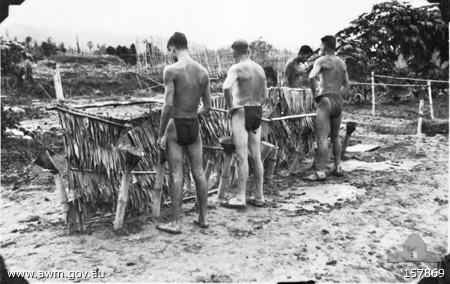 Burma-Thailand Railway. 1945. A urinal at a prisoner of war camp. The condition of the men suggests that the photograph was taken some weeks after the Japanese surrender. 