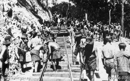 Ronsi, Burma. c. 1943. Australian and British prisoners of war (POWs) laying track on the Burma-Thailand railway 1943