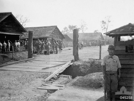The starting point of the Burmese section of the Burma-Thailand railway. This photograph shows a Japanese soldier standing guard at the guard house near the entrance gate